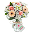 This luminous floral arrangement draws inspiration from Cranham's peaceful streets and colourful autumn sunsets. At centre stage, classic, full-bodied roses in warm peach-pink hues blossom with quiet sophistication. Nearby, two bright peach gerbera daisies, their bold faces and rich chocolate centers, offer cheerful contrast, echoing the community's lively spirit on a market day. Wispy clouds of white baby's breath float and fill in around the dominant blooms, while sprinklings of white chrysanthemums, some sporting subtle lime-green eyes, contribute a soft, inviting fullness to the bouquet. Interspersed eucalyptus sprigs add depth and a grassy, outdoor scent-like the air near local woods after rain. Everything is gathered in a refined, clear glass vase whose surface catches the light and reveals vibrant green stems within. A natural twine tied around the neck secures a white tag, perfect for a short sentiment on occasions such as Mother's Day, a birthday, or a gentle thank-you. This arrangement showcases the thoughtful skill of Cranham's florists and is available for delivery to neighbours and loved ones throughout the area, brightening homes from St. Mary's Lane to the heart of the village.